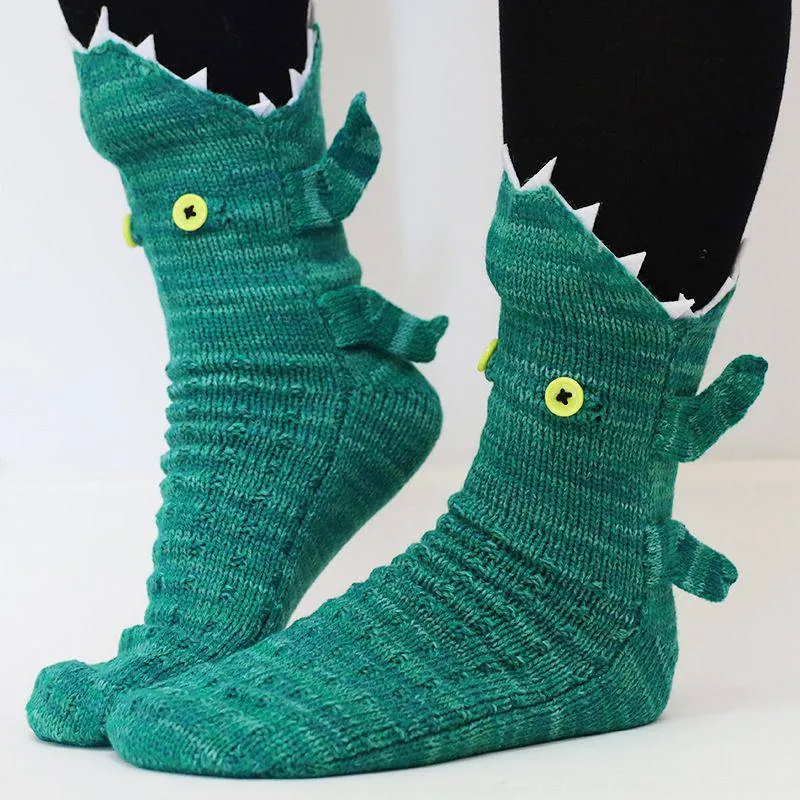A pair of green crocodile Wildsoles worn on feet